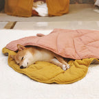 A dog sleeping on yellow leaf leaf-shaped blanket