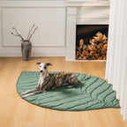A dog sitting on gray  leaf shape blanket