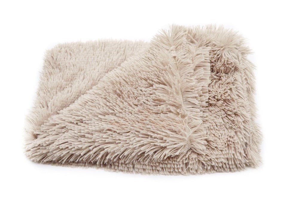 Beige fluffy blanket on a white background